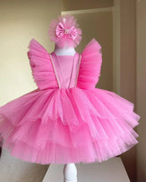 Front view of a pink tulle tiered flower dress for girls, showcasing soft layers and delicate floral details.