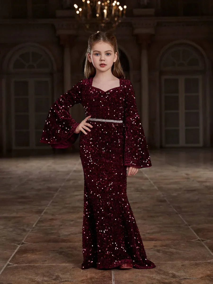 Styled image of the red shimmering velvet girls mermaid dress paired with matching accessories, perfect for special occasions.