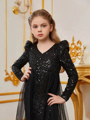 Close-up of black sequin bodycon dress showing intricate sequin and tulle texture.