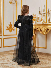 Full-length view of black bodycon party dress with shimmer effect and soft tulle layer.