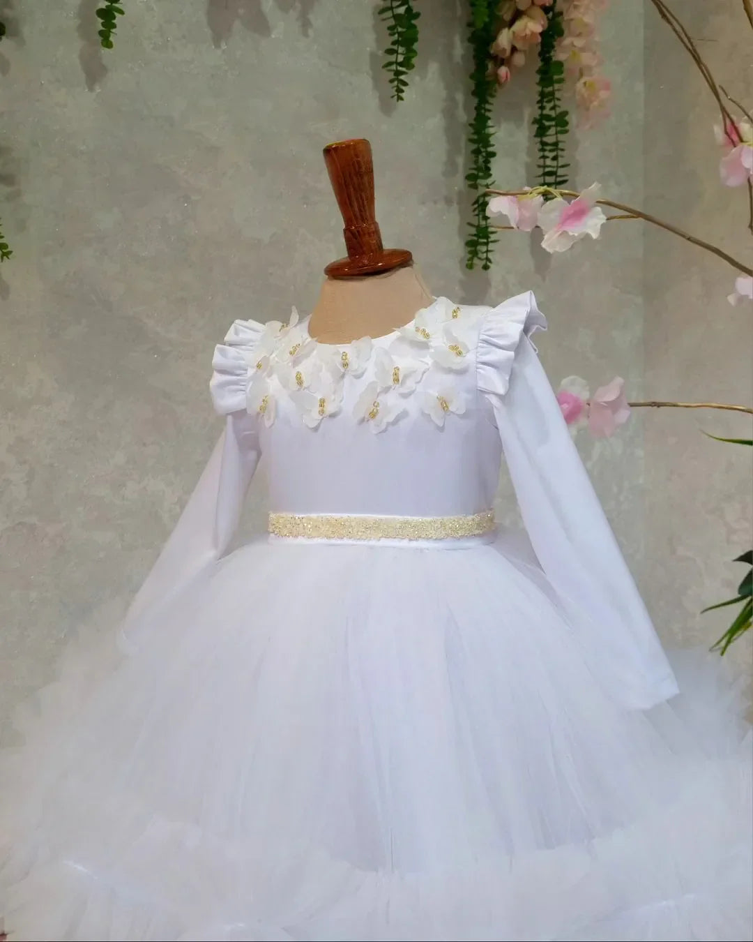 Side view of white dress with elegant butterfly embellishments for special occasions.