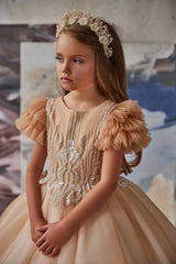 Side profile of champagne tulle flower girl gown with puff sleeves