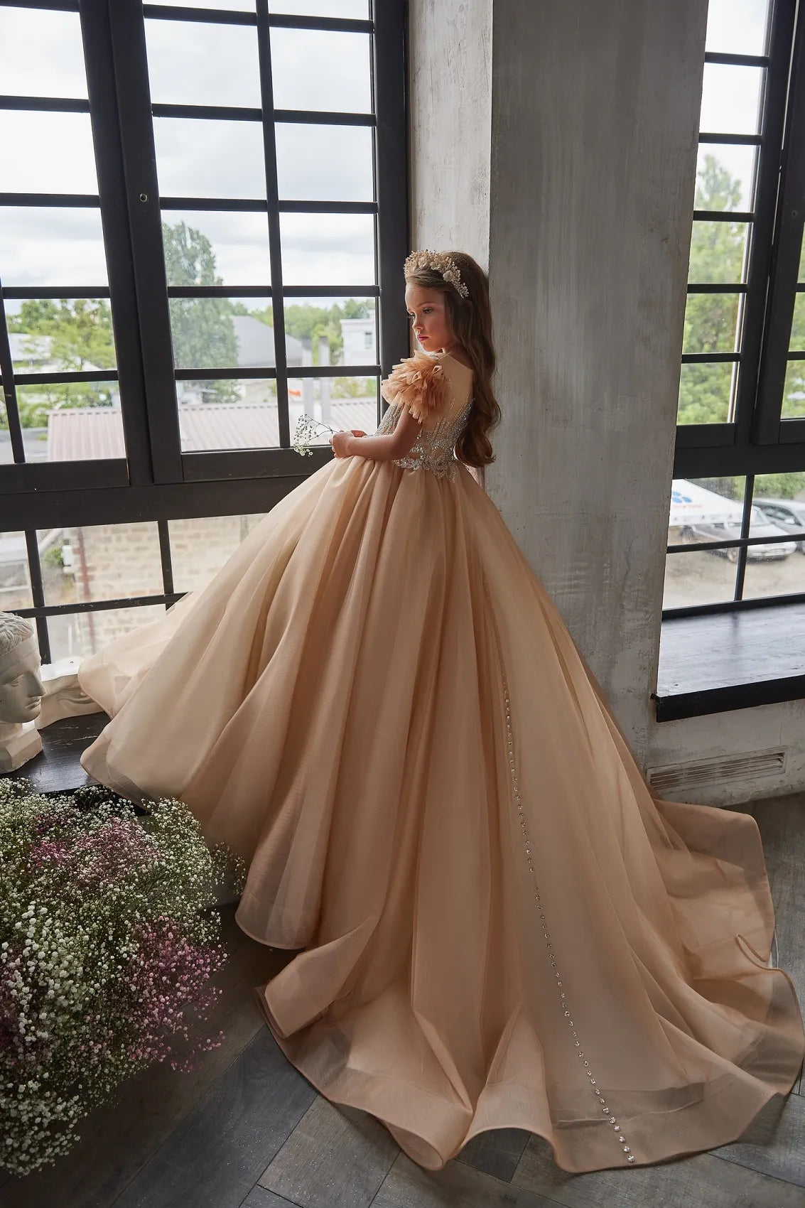 Back view of luxury champagne flower girl dress with button closure