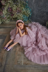Front view of Ruffled Girls' Luxury Tulle Dress in blush pink, featuring tiered layers and cascading design.