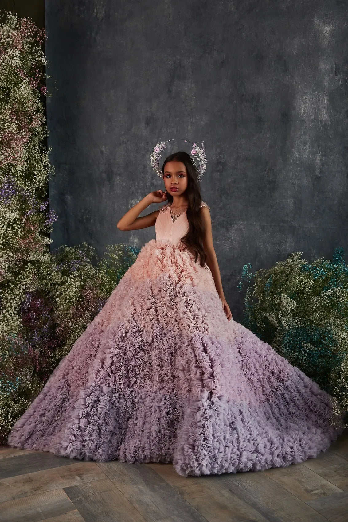 Front angle of ruffled ombré flower girl dress in pink and lavender.