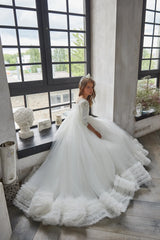 Side profile of White Lace Flower Girl Dress with flowing tulle skirt and ruffled hem