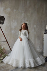 Front view of White Lace Flower Girl Dress with long sleeves and ruffled hem