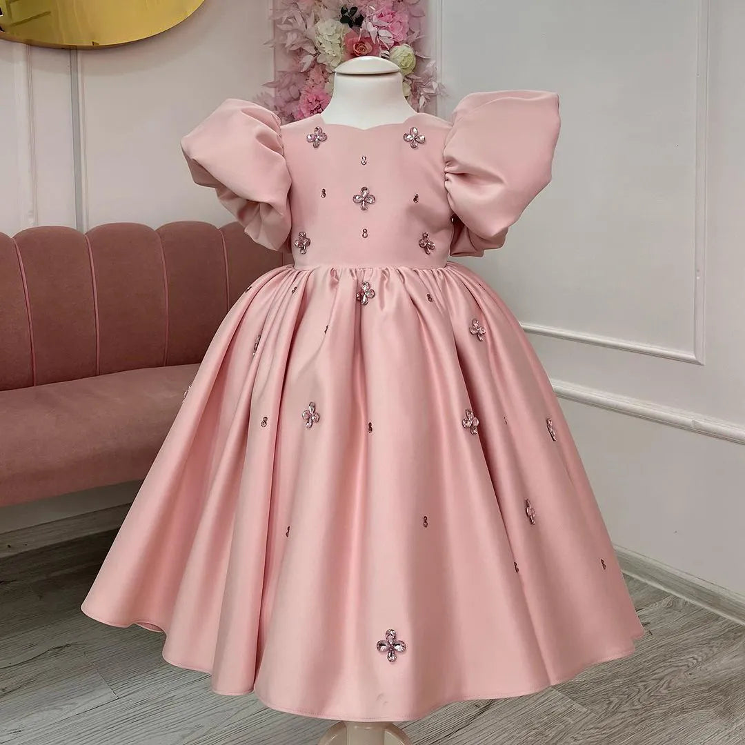 Front view of a pink princess gown with voluminous puffy sleeves, perfect for birthdays and formal events.